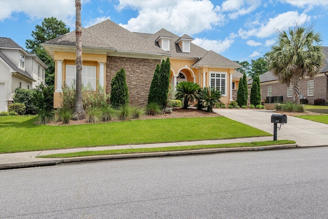 4120 Shady Oaks Dr, Martinez, GA 30907 - traditional home featuring stucco siding, a front yard, concrete driveway, stone siding, and a shingled roof