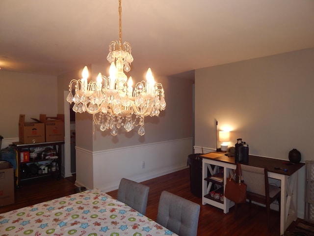 dining room with a notable chandelier and dark hardwood / wood-style flooring