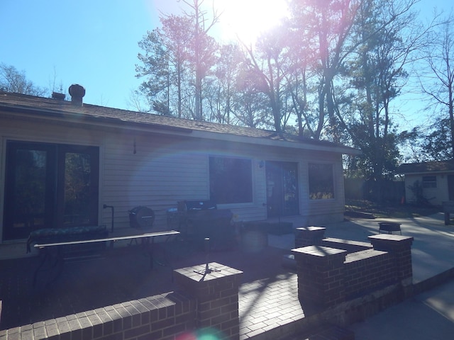 back of property featuring an outdoor living space and a patio area