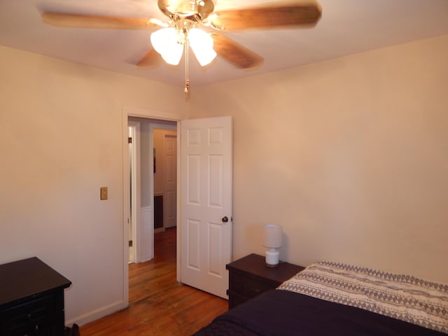 bedroom featuring ceiling fan and hardwood / wood-style flooring