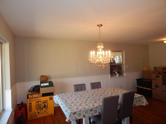 dining space with dark hardwood / wood-style flooring and a notable chandelier