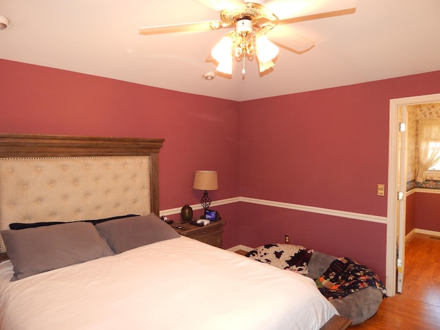 bedroom with wood-type flooring and ceiling fan