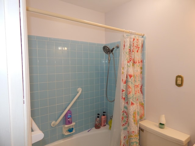 bathroom featuring shower / bath combo and toilet