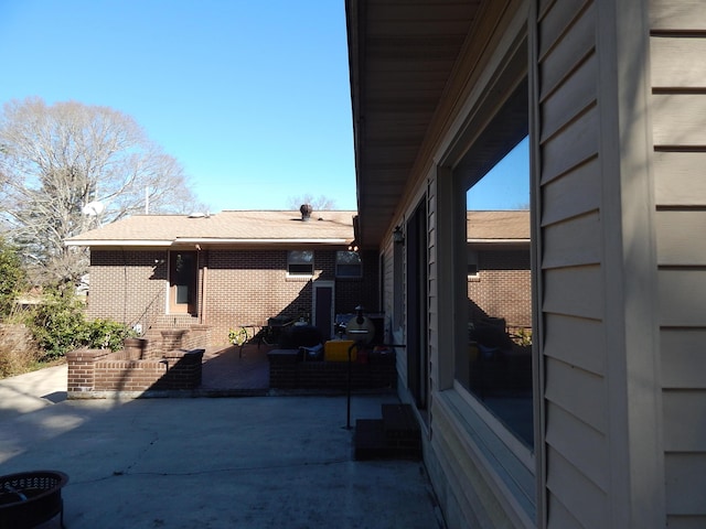 view of side of property featuring a patio area