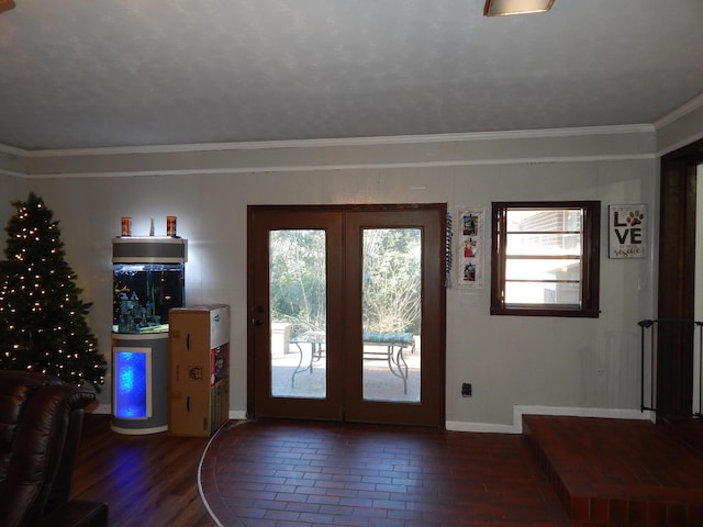 entryway featuring crown molding, dark hardwood / wood-style flooring, and french doors