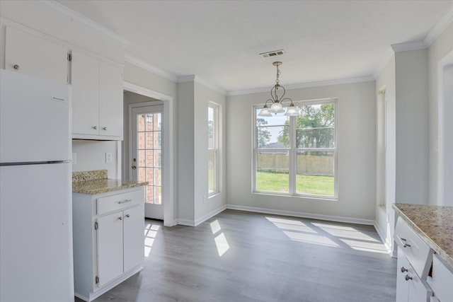 301 Cobblestone Ct, Martinez, GA 30907 - kitchen with freestanding refrigerator, wood finished floors, ornamental molding, white cabinetry, and hanging light fixtures