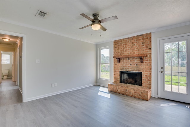 301 Cobblestone Ct, Martinez, GA 30907 - unfurnished living room with plenty of natural light, wood finished floors, a ceiling fan, crown molding, and a brick fireplace