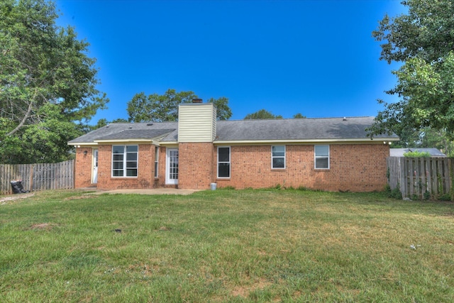 301 Cobblestone Ct, Martinez, GA 30907 - back of house with a fenced backyard, a chimney, and brick siding