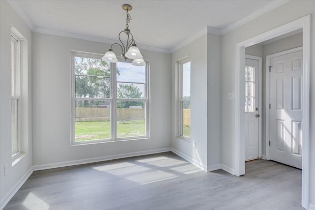 301 Cobblestone Ct, Martinez, GA 30907 - unfurnished dining area featuring wood finished floors, plenty of natural light, a chandelier, and crown molding