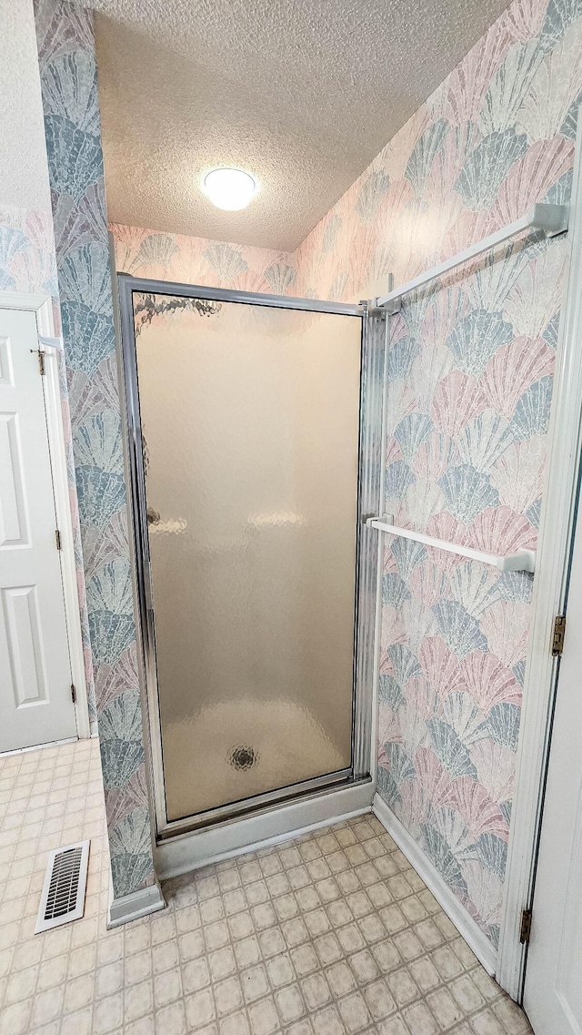 206 W Amelia Dr, Martinez, GA 30907 - bathroom with tile patterned floors, a textured ceiling, a stall shower, visible vents, and wallpapered walls