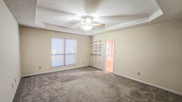 206 W Amelia Dr, Martinez, GA 30907 - carpeted empty room with a ceiling fan, a textured ceiling, a raised ceiling, baseboards, and visible vents