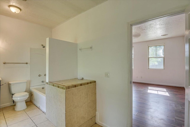 2028 Wharton Dr, Augusta, GA 30904 - bathroom featuring a textured ceiling, shower / bathtub combination, and wood finished floors