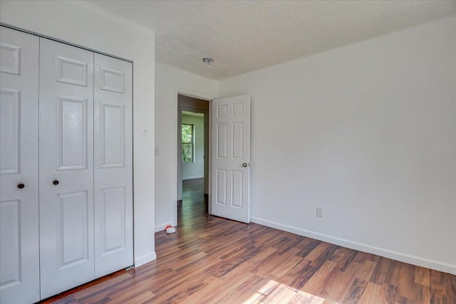 2028 Wharton Dr, Augusta, GA 30904 - unfurnished bedroom with wood finished floors, a closet, and a textured ceiling