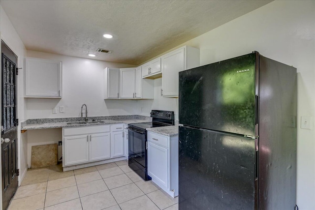 2028 Wharton Dr, Augusta, GA 30904 - kitchen with black appliances, white cabinets, a textured ceiling, light tile patterned flooring, and recessed lighting