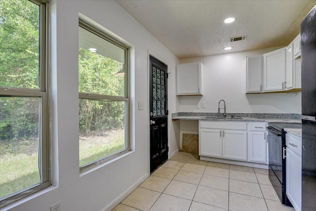 2028 Wharton Dr, Augusta, GA 30904 - kitchen featuring black electric range oven, white cabinets, light tile patterned flooring, light stone counters, and recessed lighting