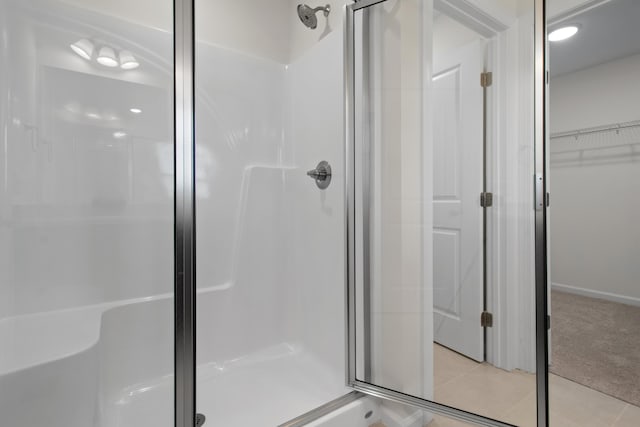 bathroom with walk in shower and tile patterned floors