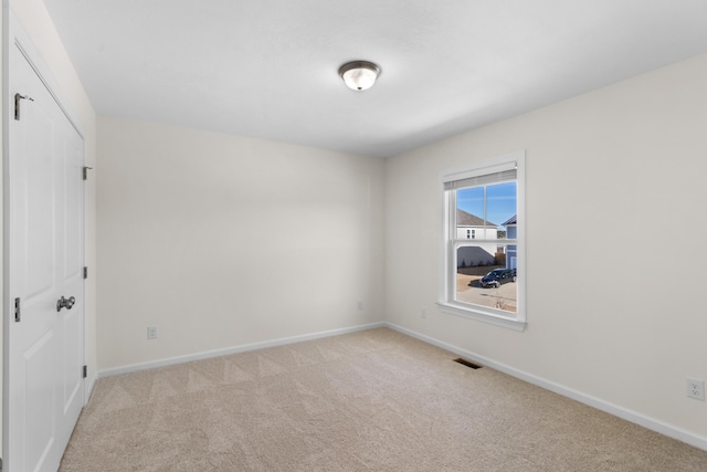 empty room with light colored carpet