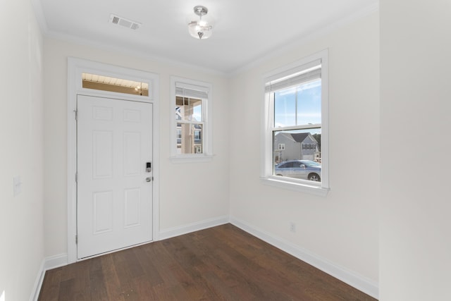 foyer entrance featuring dark wood-type flooring and crown molding