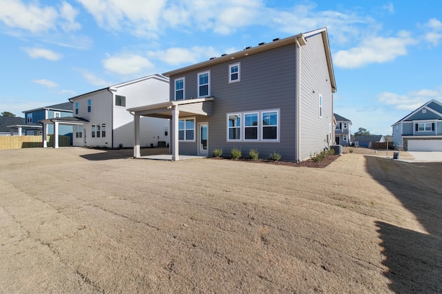 rear view of property with central air condition unit and a patio