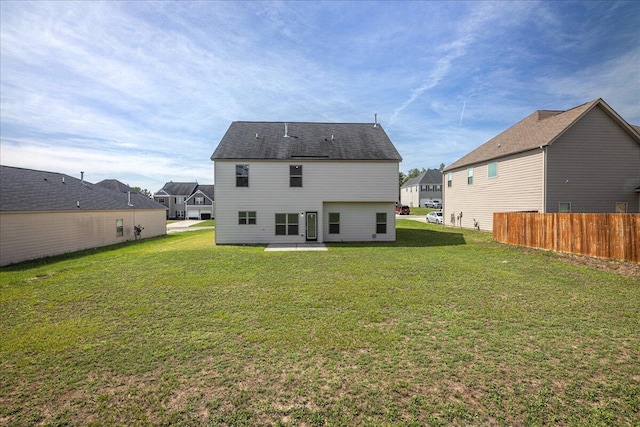 rear view of property with a lawn and a patio area