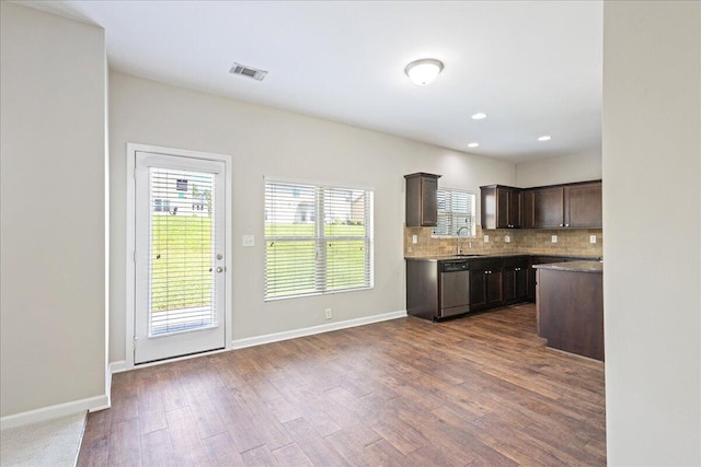 kitchen with dishwasher, dark brown cabinets, a healthy amount of sunlight, and sink