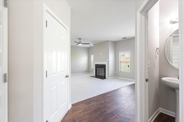 bathroom with hardwood / wood-style flooring and ceiling fan