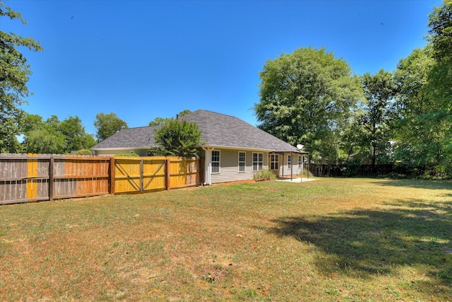 rear view of property with a shingled roof
