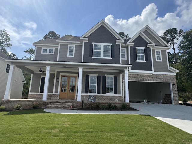 642 River Oaks Ln, Evans, GA 30809 - craftsman-style home with brick siding, a garage, covered porch, concrete driveway, and a front yard