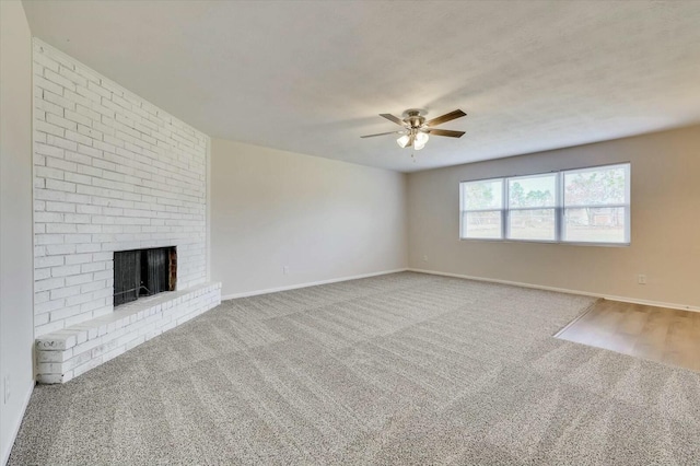 unfurnished living room featuring a fireplace, carpet floors, and ceiling fan