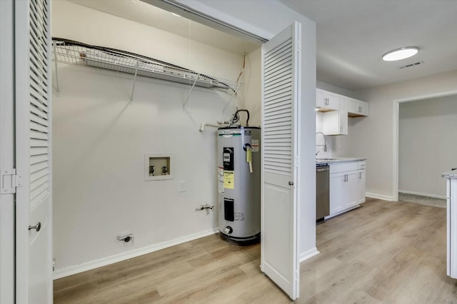 laundry room featuring light wood-type flooring, electric water heater, sink, and hookup for a washing machine