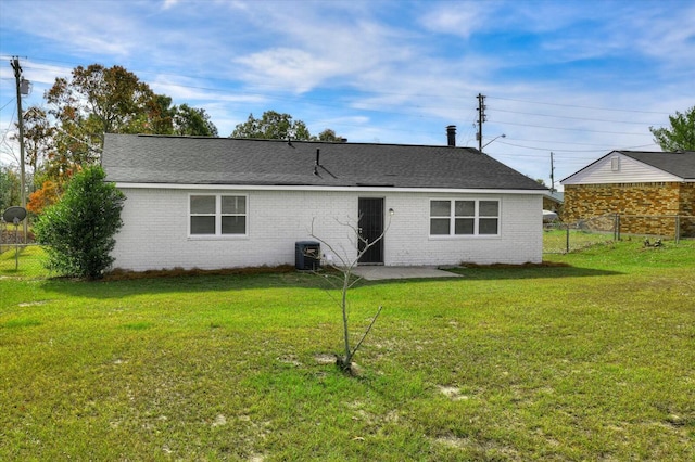 back of property with a patio area and a yard