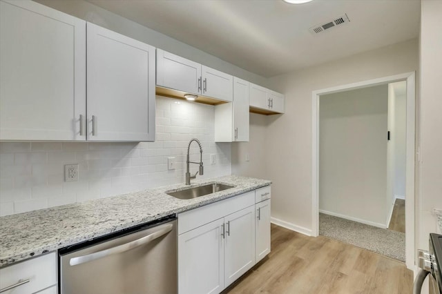 kitchen featuring dishwasher, white cabinets, light hardwood / wood-style flooring, and sink