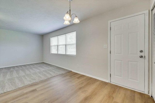 interior space with light wood-type flooring and a notable chandelier