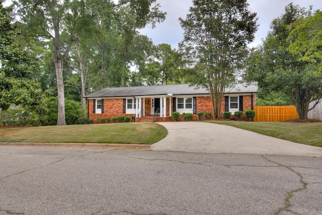 ranch-style home with a front lawn