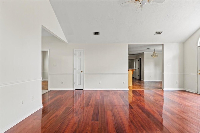 4500 Marthas Way, Grovetown, GA 30813 - empty room with wood finished floors, ceiling fan, baseboards, a chandelier, and vaulted ceiling