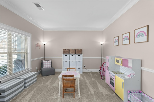 recreation room featuring baseboards, carpet, visible vents, and crown molding