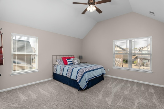 carpeted bedroom with lofted ceiling, baseboards, and visible vents