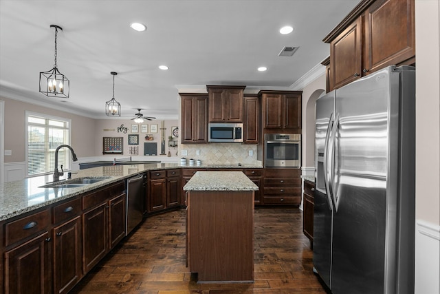 kitchen with crown molding, stainless steel appliances, visible vents, a sink, and dark brown cabinetry