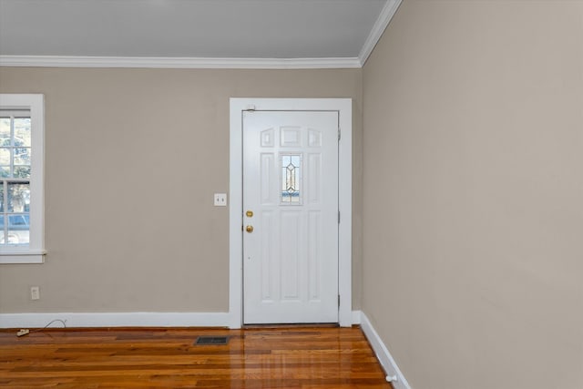 foyer entrance with crown molding and hardwood / wood-style flooring