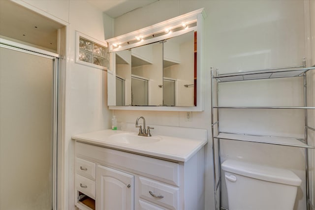 full bathroom with vanity, toilet, and an enclosed shower