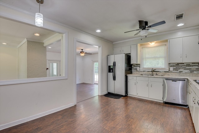 kitchen with stainless steel appliances, a sink, a ceiling fan, ornamental molding, and decorative backsplash
