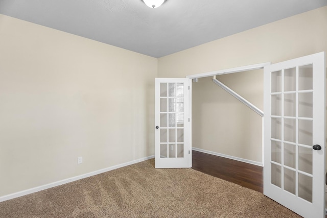 empty room featuring carpet and french doors