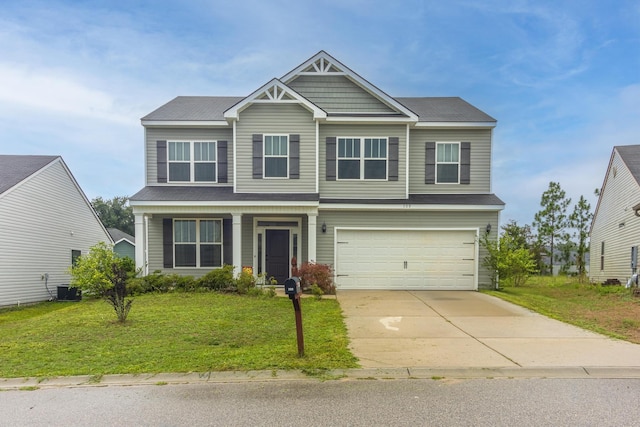 craftsman house featuring central air condition unit, a front lawn, and a garage