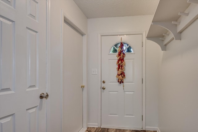 2382 Patrick Ave, Hephzibah, GA 30815 - entryway featuring baseboards, a textured ceiling, and wood finished floors