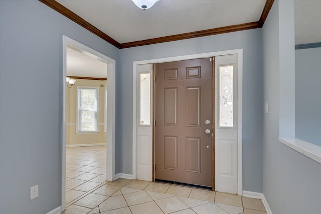 entryway featuring crown molding, light tile patterned floors, baseboards, and a textured ceiling