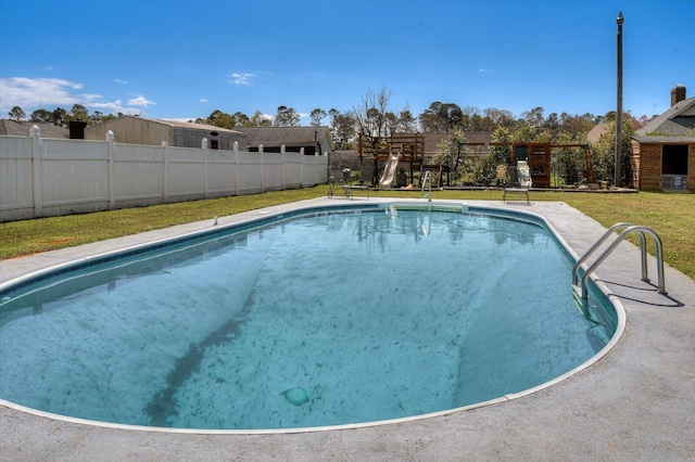 view of pool with a yard, fence, a fenced in pool, and a playground