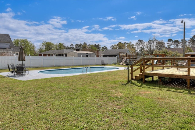view of yard featuring a fenced in pool, a patio, a fenced backyard, and a playground