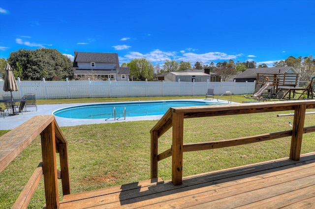 view of pool with a fenced backyard, a patio area, a fenced in pool, and a yard