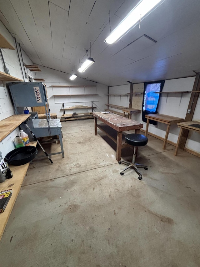 basement with a workshop area and concrete block wall
