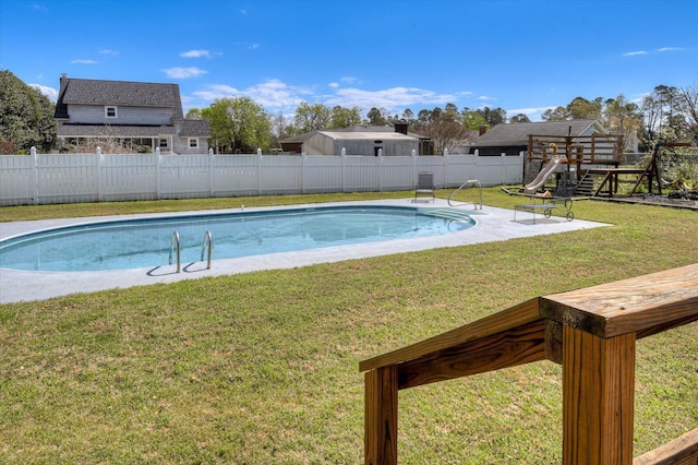 view of pool with a patio, a fenced in pool, a fenced backyard, a playground, and a lawn